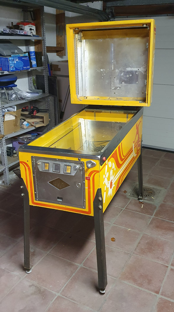 The old empty Strikes and Spares pinball cabinet used as a base